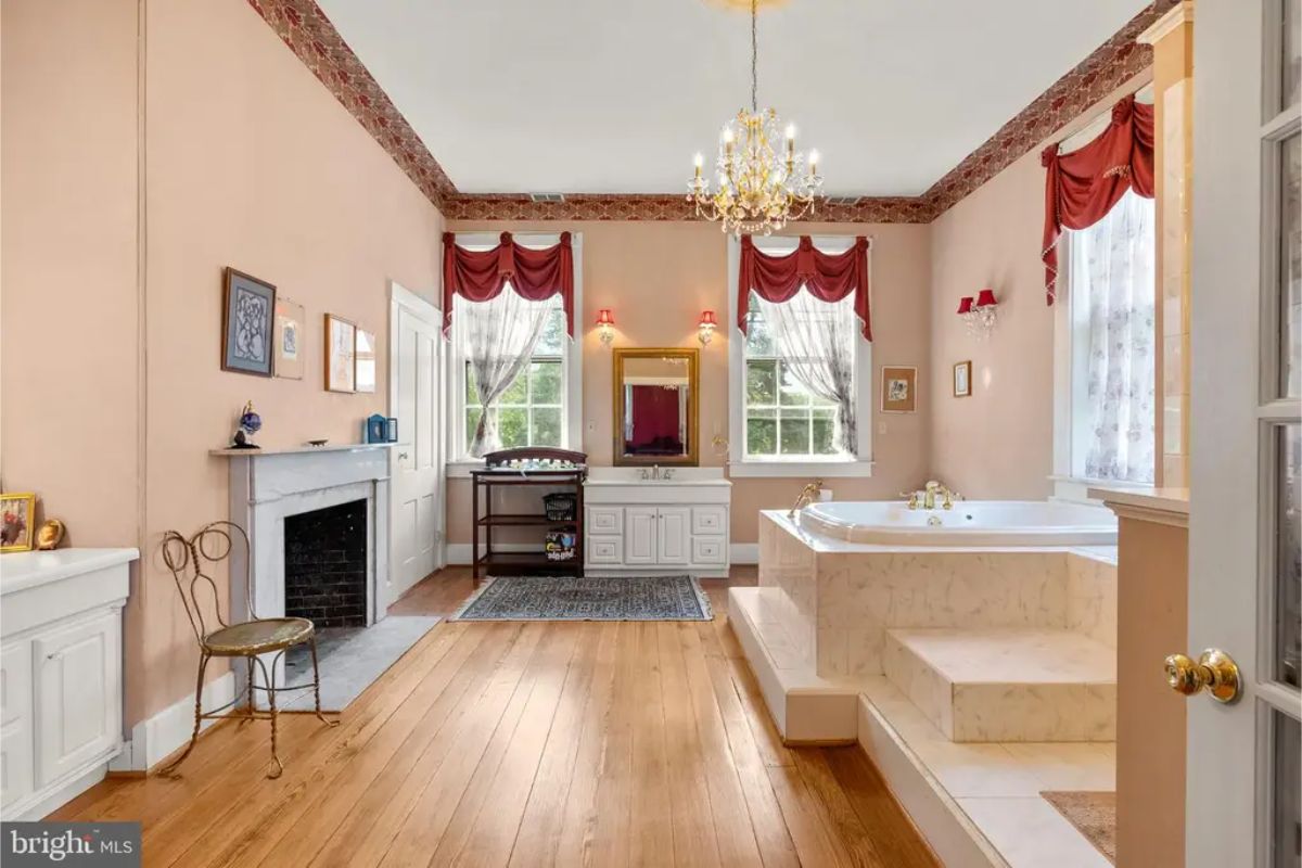 Soft peach walls create a warm and inviting ambiance in this expansive bathroom.