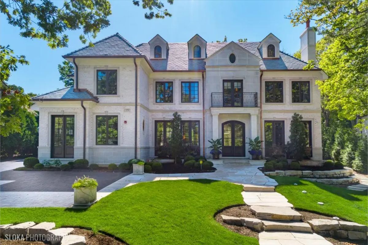 All this in Glencoe for $5,675,000. this stunning 6-bedroom, 8-bathroom, 7,000 sq. ft. home in East Glencoe combines timeless elegance with modern luxury, featuring a classic white-washed brick and limestone facade.