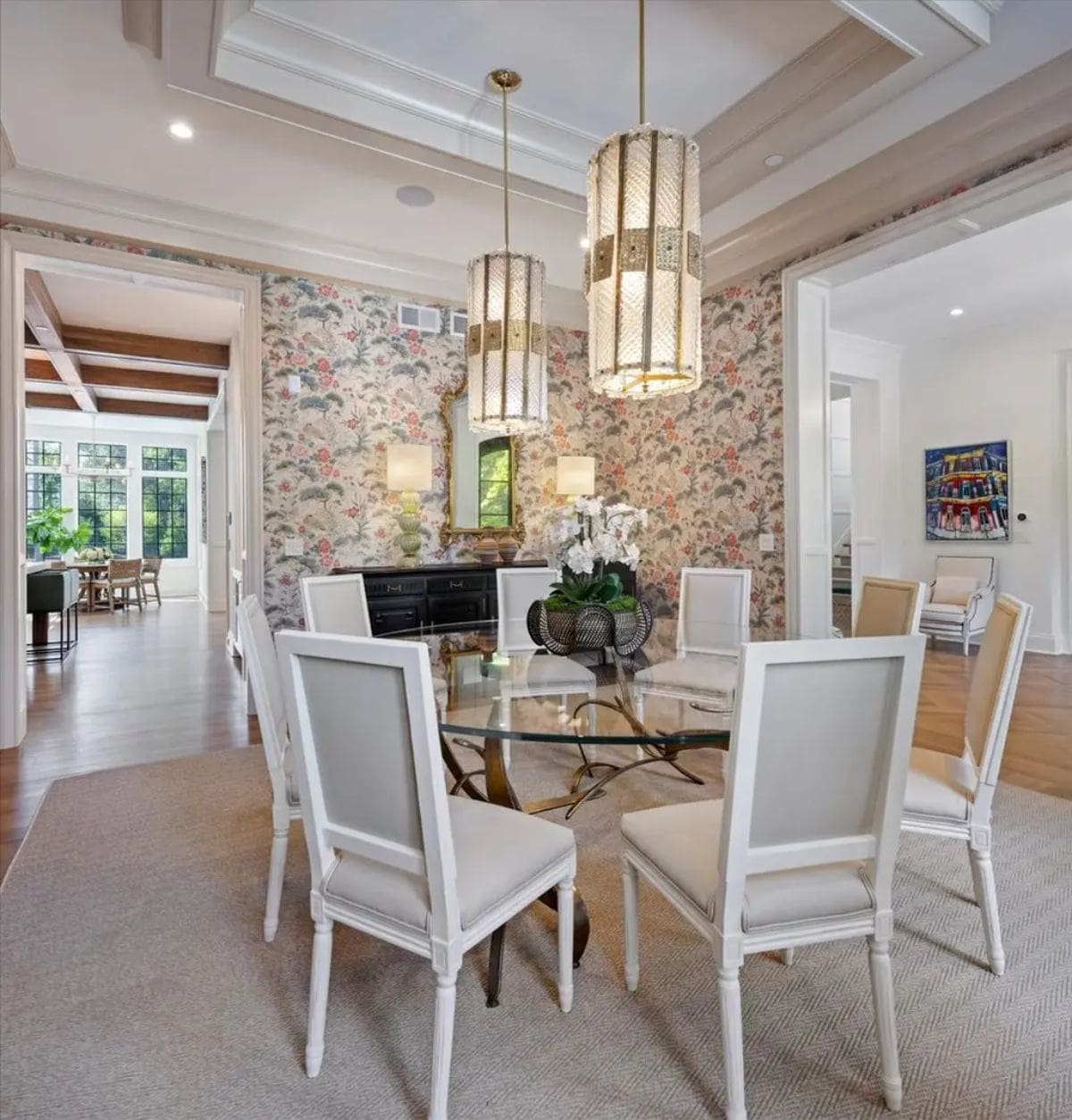 Sophisticated dining room showcasing floral-patterned wallpaper and coffered ceiling.