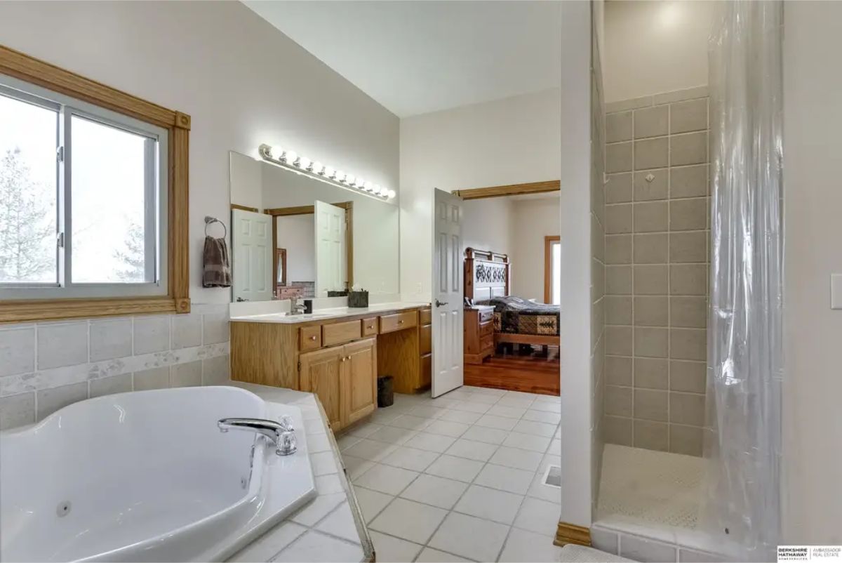 A large soaking tub, a separate tiled shower, and abundant natural light.