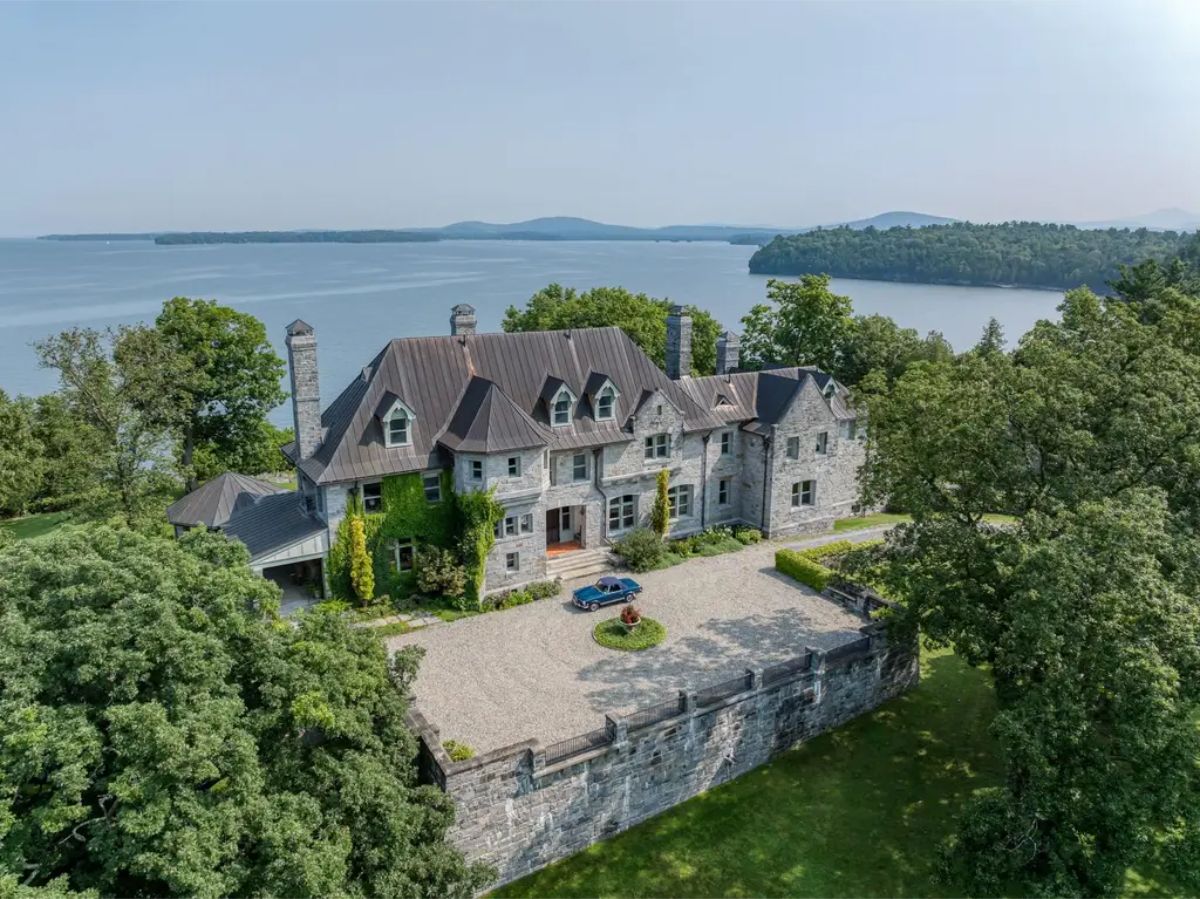 Stone-built mansion with a steeply pitched roof and dormer windows.