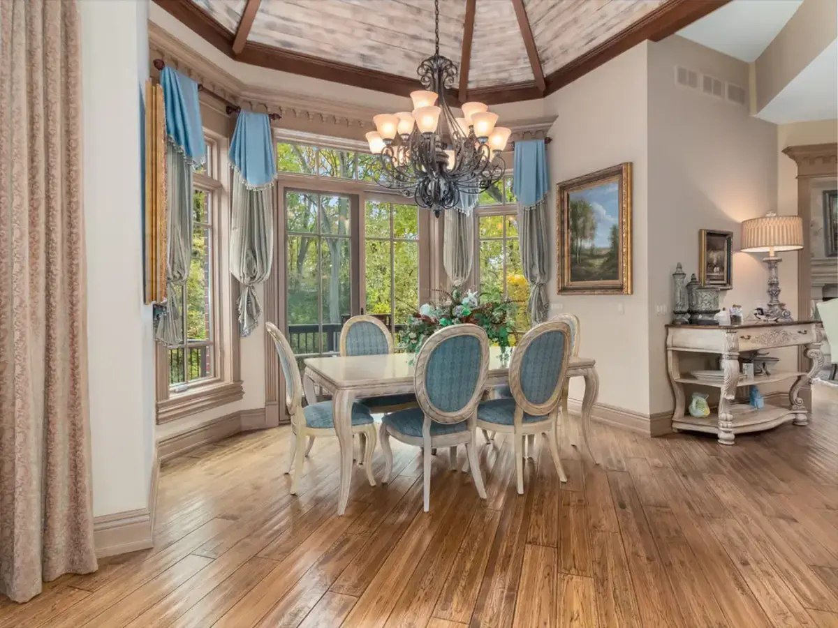 The kitchen bar area includes upholstered chairs arranged for convenience and style. 