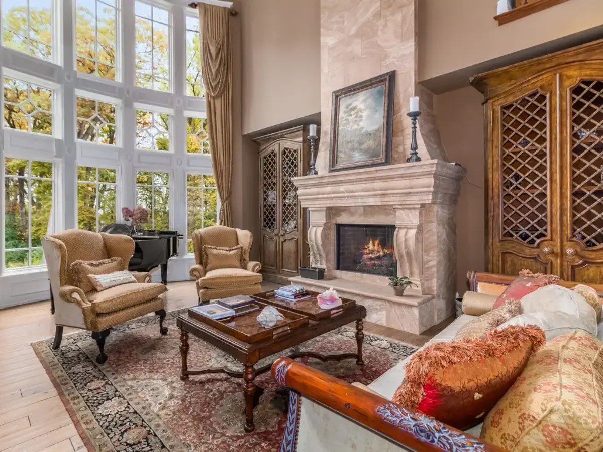 A stone fireplace anchors the great room, offering warmth and visual charm.