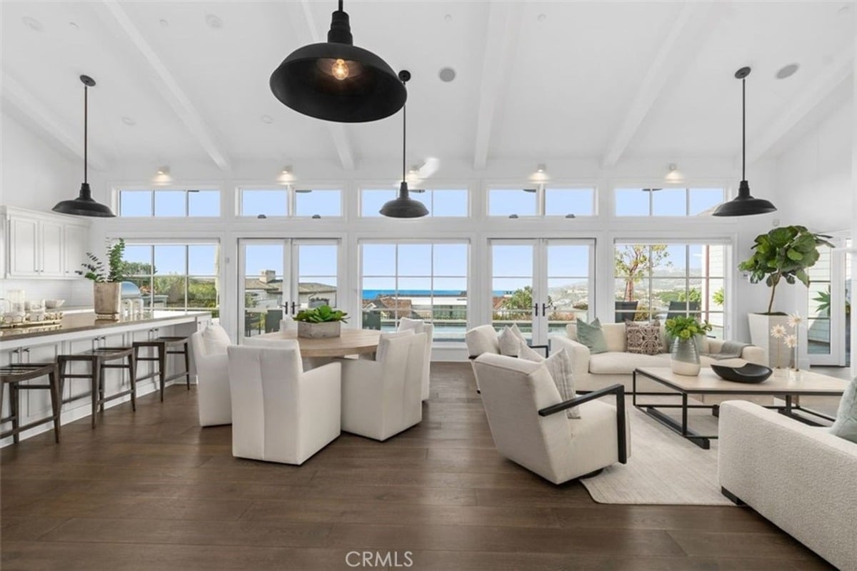 Open-concept living and kitchen space boasts panoramic ocean views.