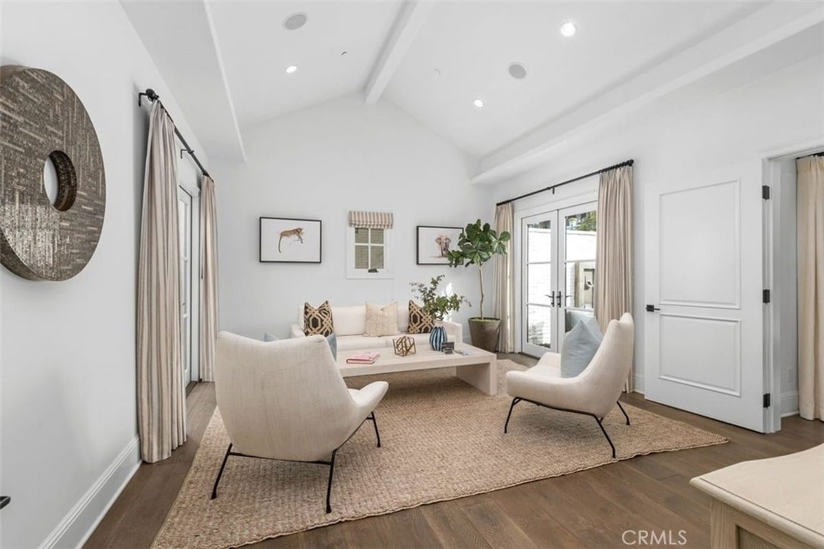 Comfortable living area with cozy chairs, a coffee table, and decorative artwork on the walls.