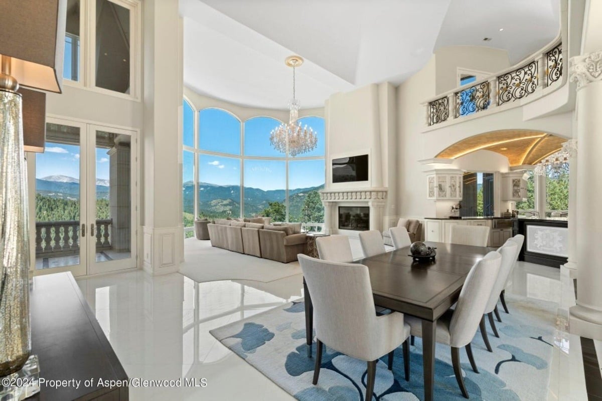 Grand windows frame breathtaking views of the surrounding landscape while filling the space with natural light.