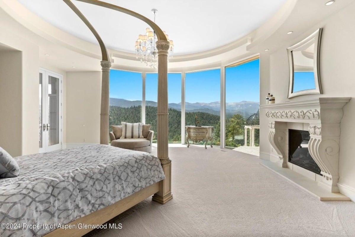 A rounded wall of windows encircles the master suite, creating an immersive connection to the natural surroundings.