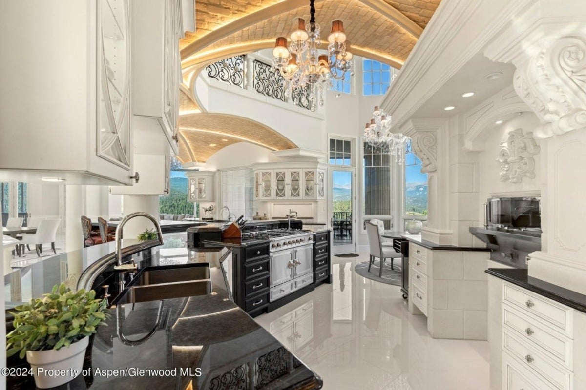Vaulted brick ceilings with recessed lighting highlight the grandeur of the kitchen.