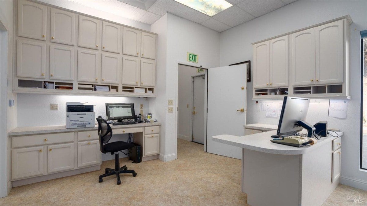 Office space includes built-in cabinetry, workspace counters, and recessed lighting.