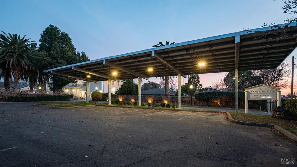 Large carport area includes lighting and private parking designation for convenience.
