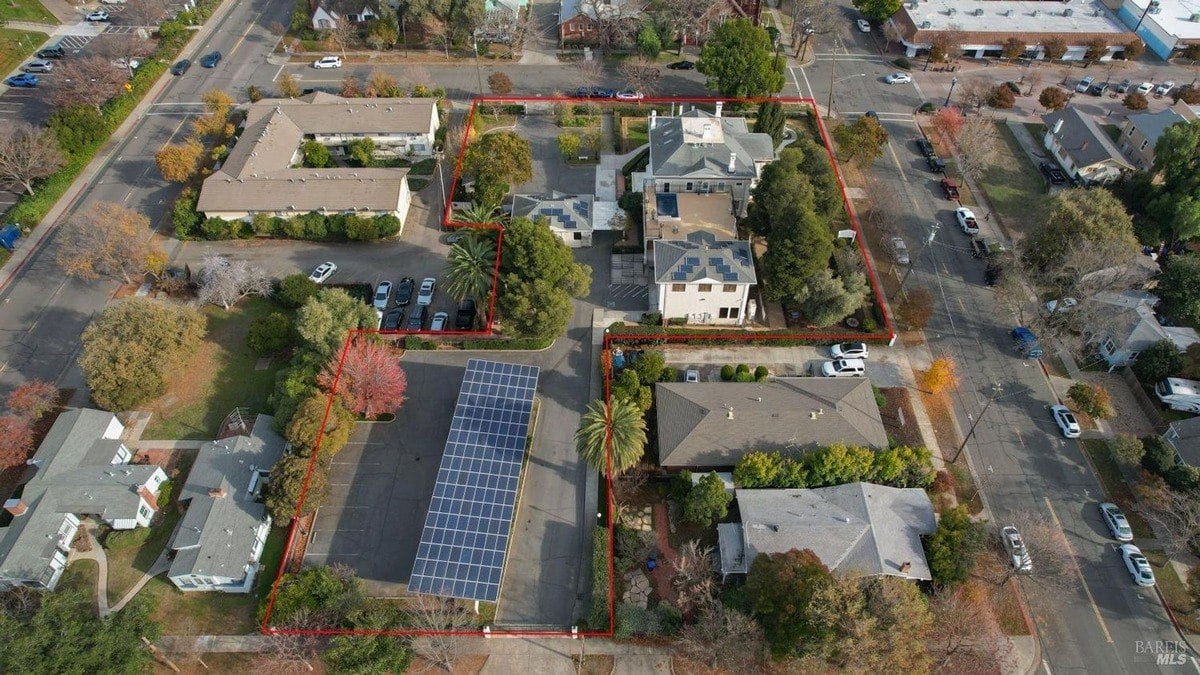 Aerial shot outlines the estate boundaries, showing buildings, solar installations, and nearby streets.