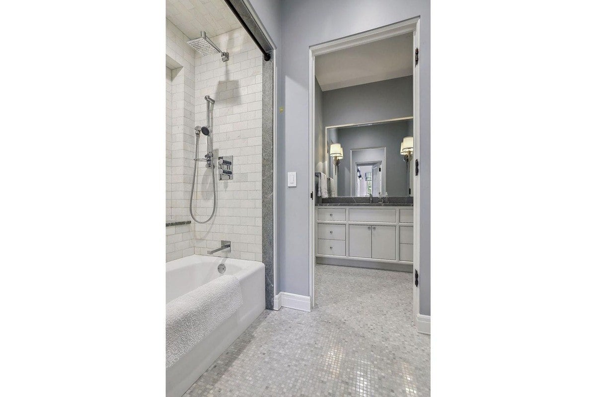 Bathroom with a soaking tub, shower, and gray tile floor.