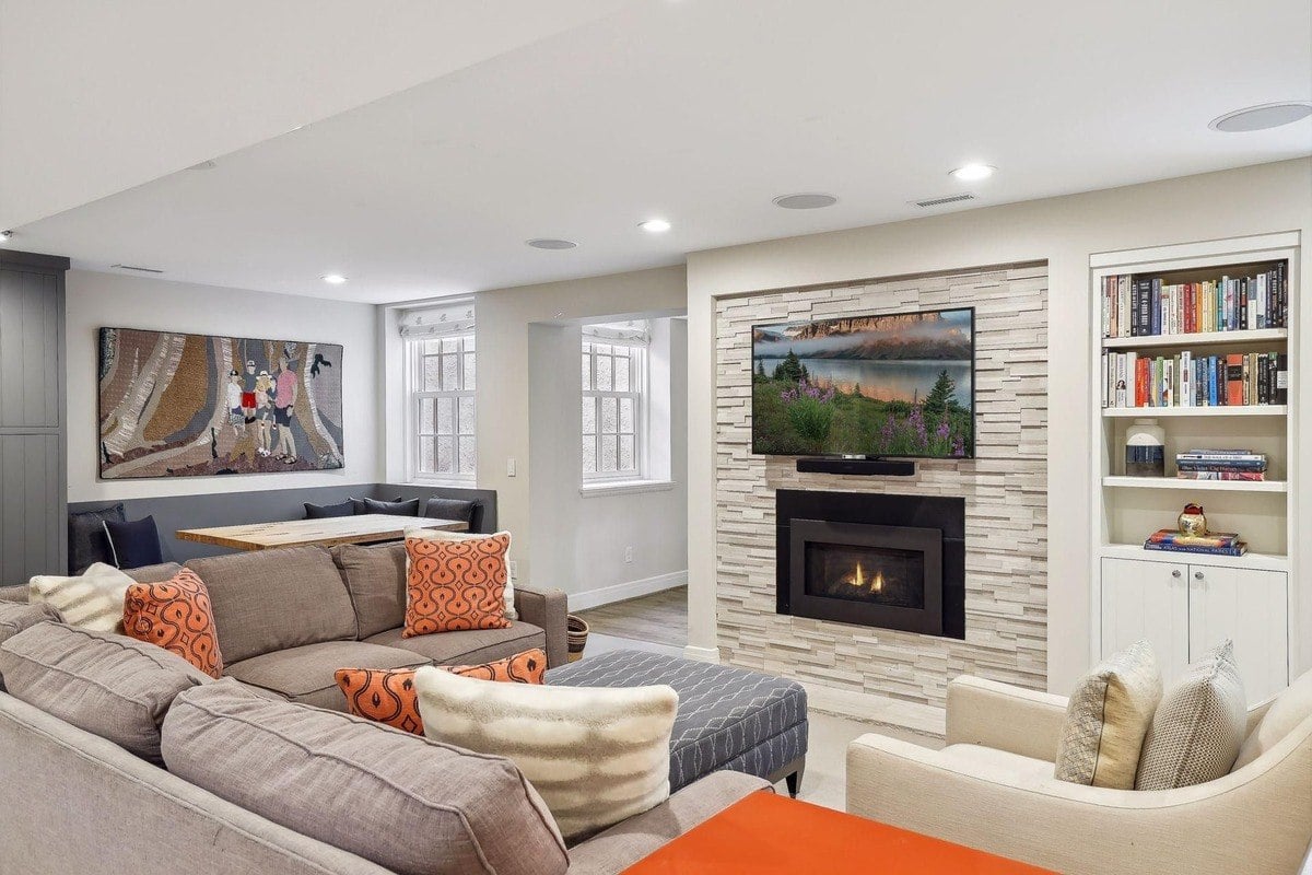 Family room with a large sectional sofa, fireplace, and built-in bookcase.