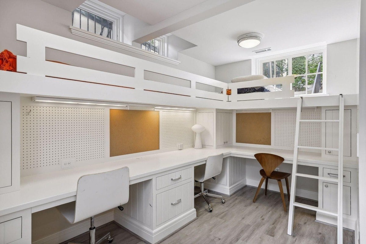 Room with a built-in bunk bed, desks, and pegboard walls.