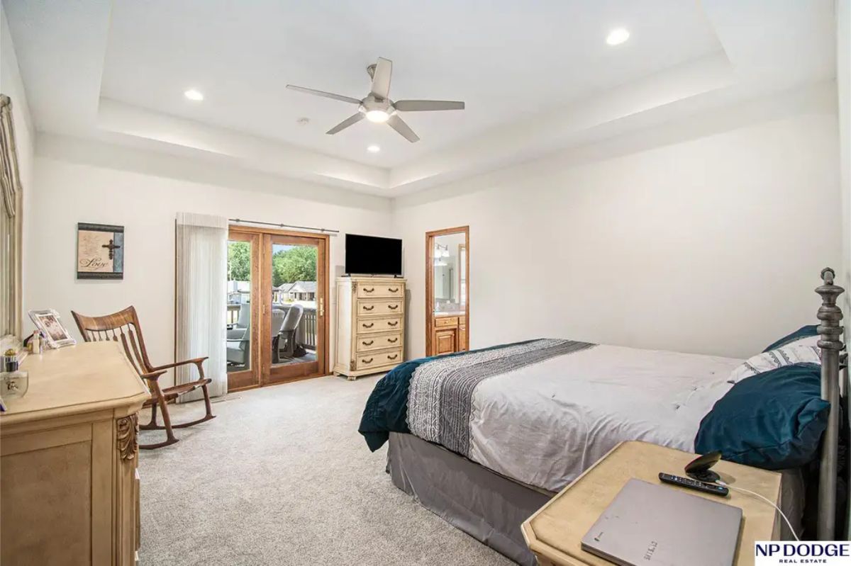 The master bedroom offers a comfortable retreat with tray ceilings and recessed lighting.