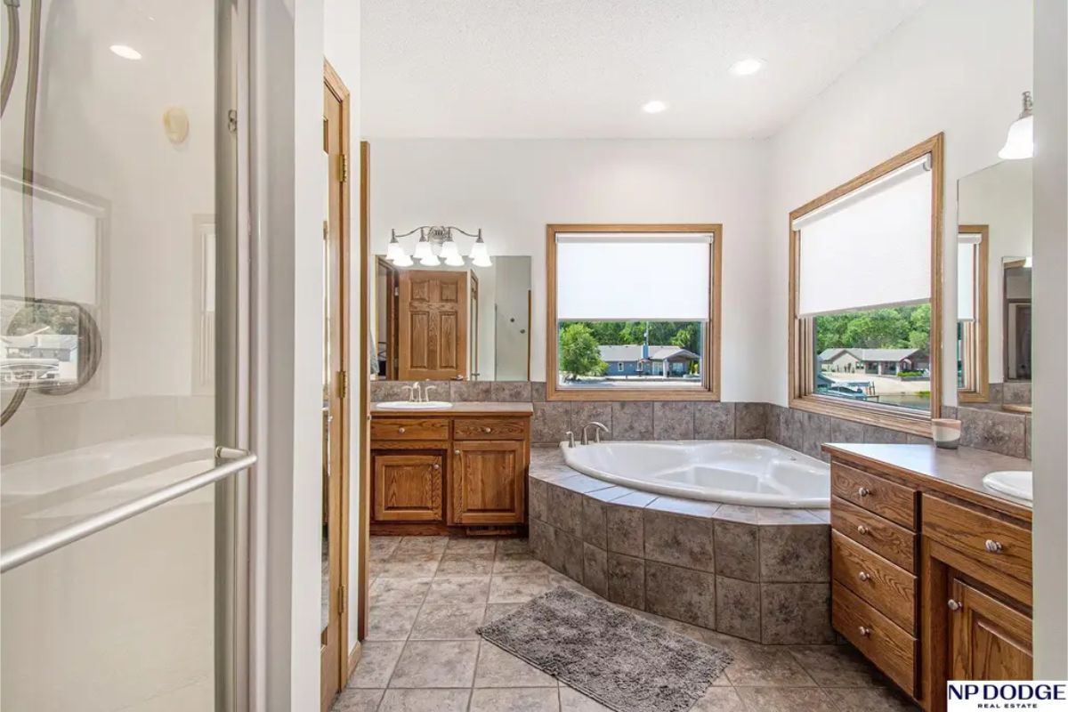 A corner whirlpool tub surrounded by tiled walls, creating a relaxing retreat.