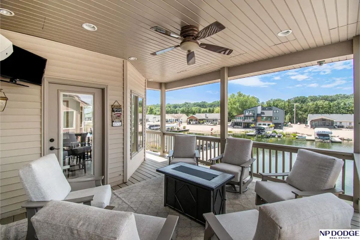 Covered patio offers a comfortable seating area with panoramic views of the water, ideal for relaxation or entertaining.
