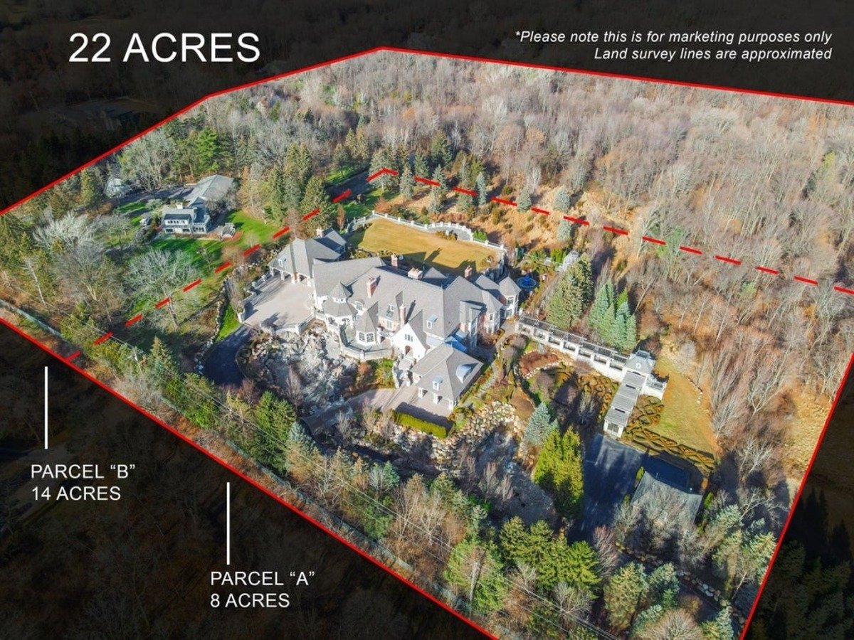 Aerial view showcases the expansive 22-acre estate with a main residence, gardens, and additional structures.