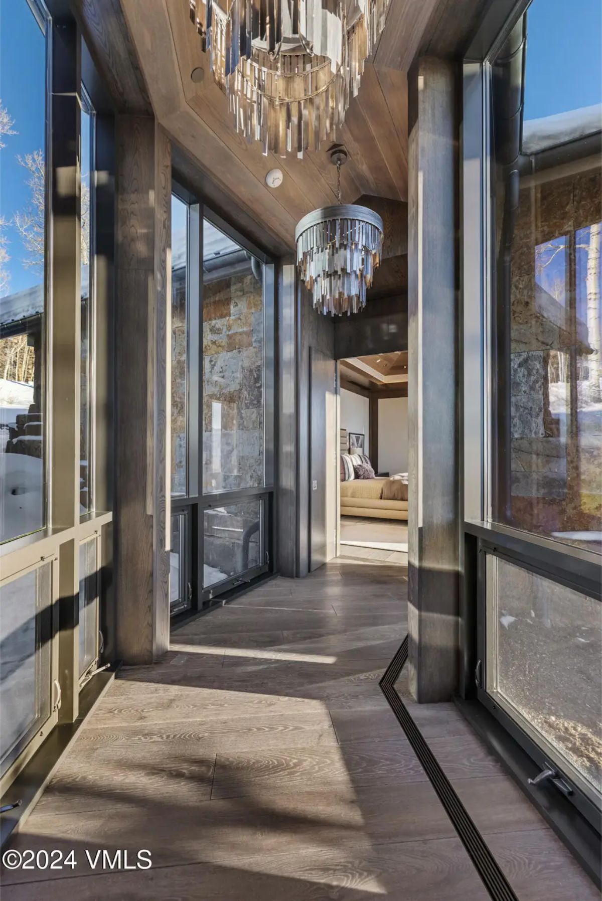 Transitional space with floor-to-ceiling windows offers an abundance of natural light and seamless outdoor views
