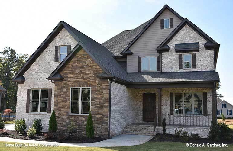 Traditional Brick and Stone Facade with a Touch of Rustic Charm