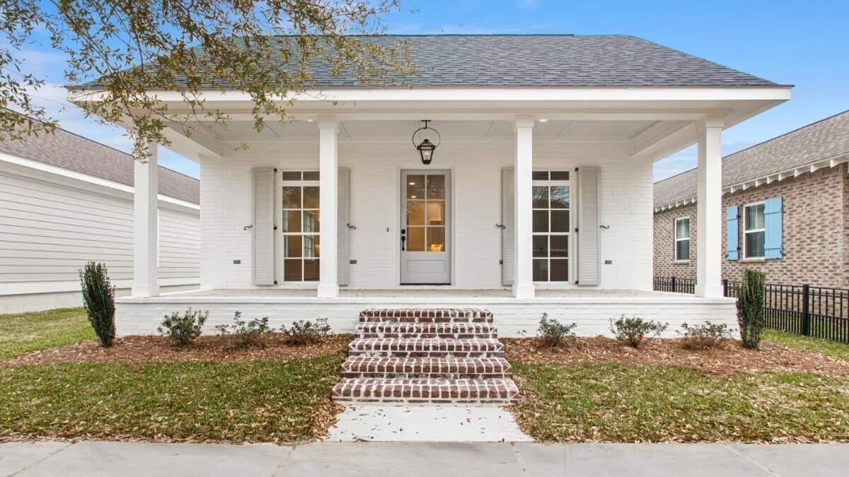 Charming White Brick Facade with Inviting Front Porch