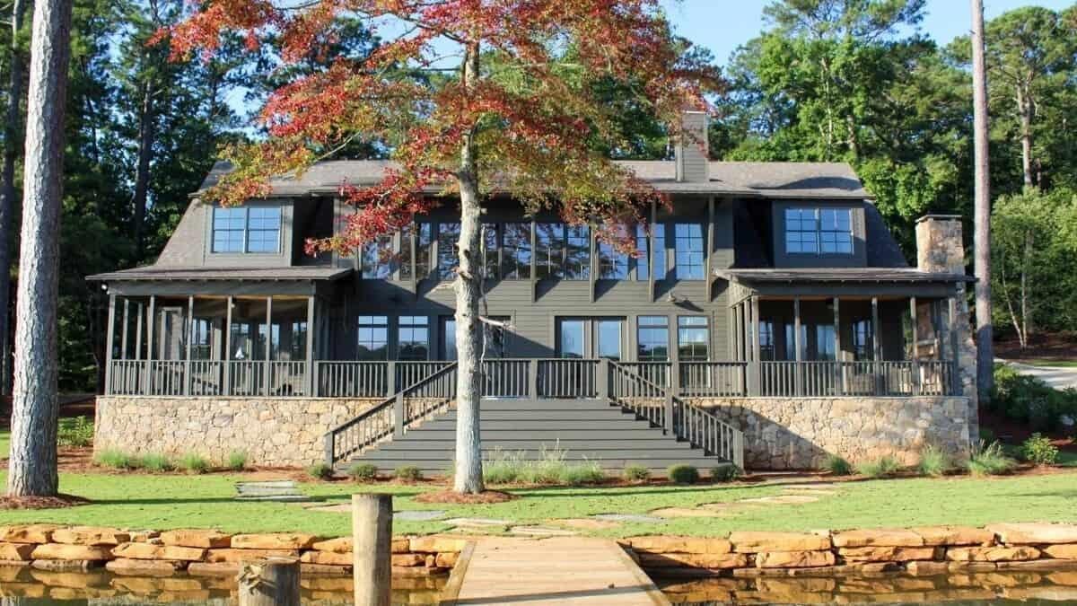 Stately Lakefront Home with Expansive Windows and Stone Foundation