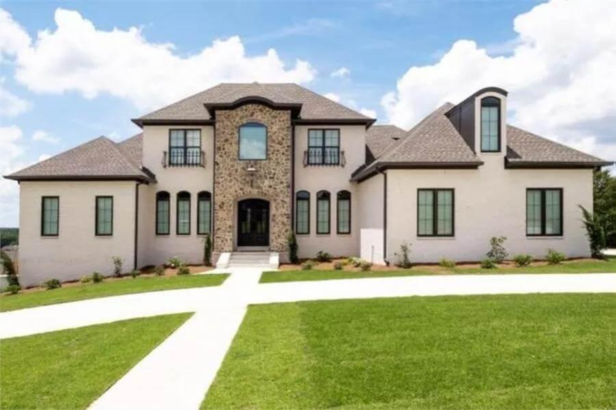 Grand Entryway with Stone Facade and Dormer Windows