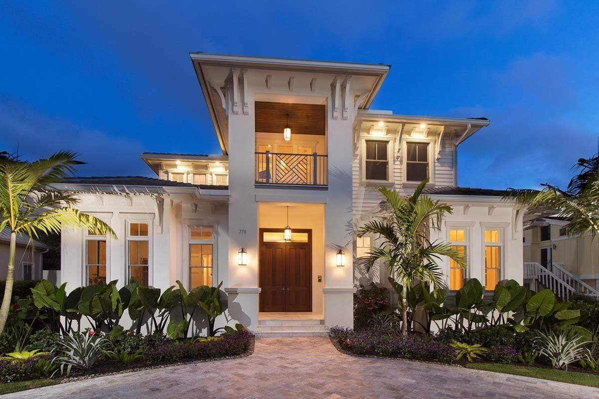 Elegant Coastal Home with Symmetrical Facade and Lush Landscaping