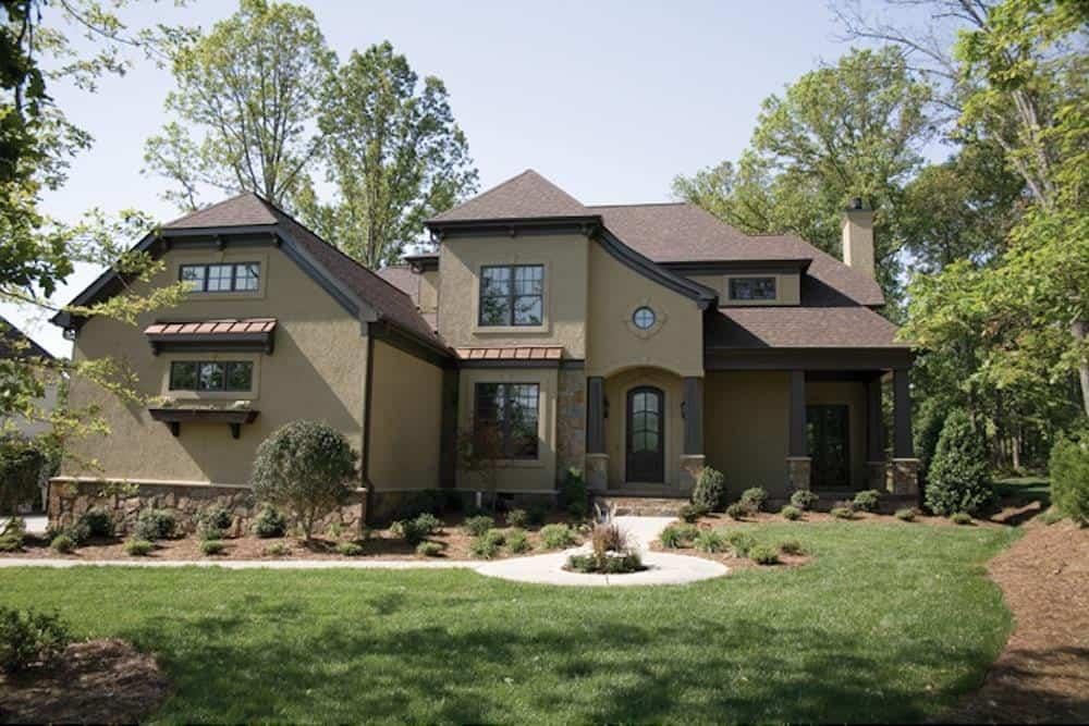 Elegant Two-Story Home with Dramatic Rooflines and Arched Entry