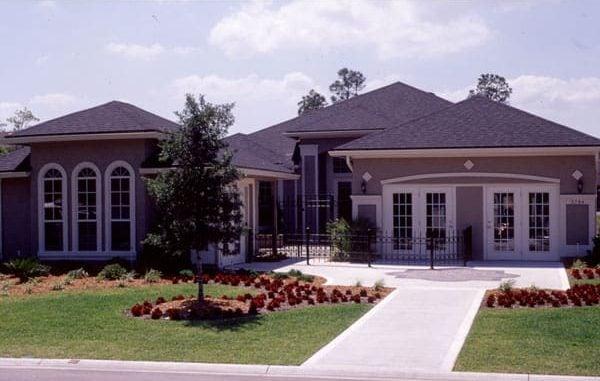Elegant Home with Arched Windows and Symmetrical Design
