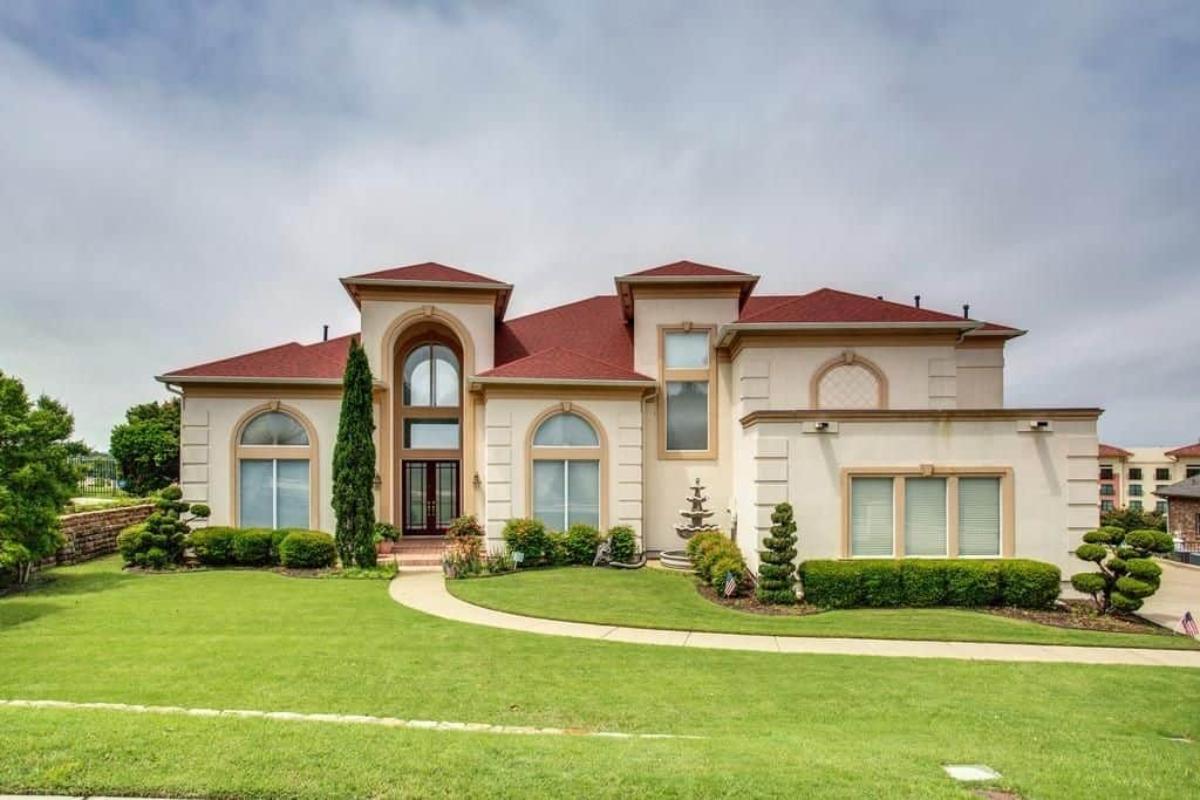 Grand Facade with Striking Red Roof and Symmetrical Windows