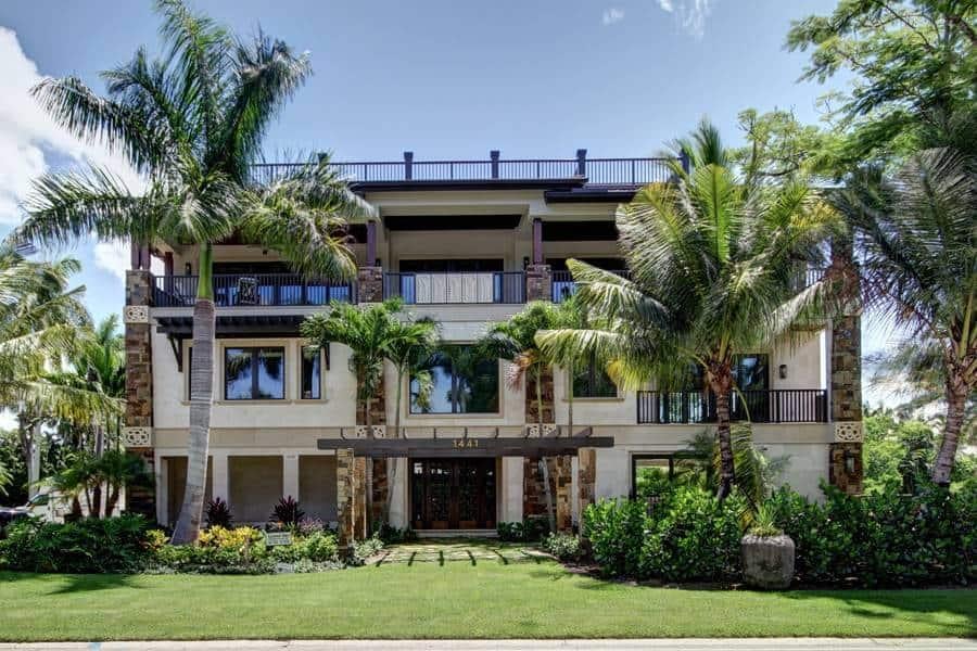 Tropical Villa Framed by Lush Palms and Stone Accents