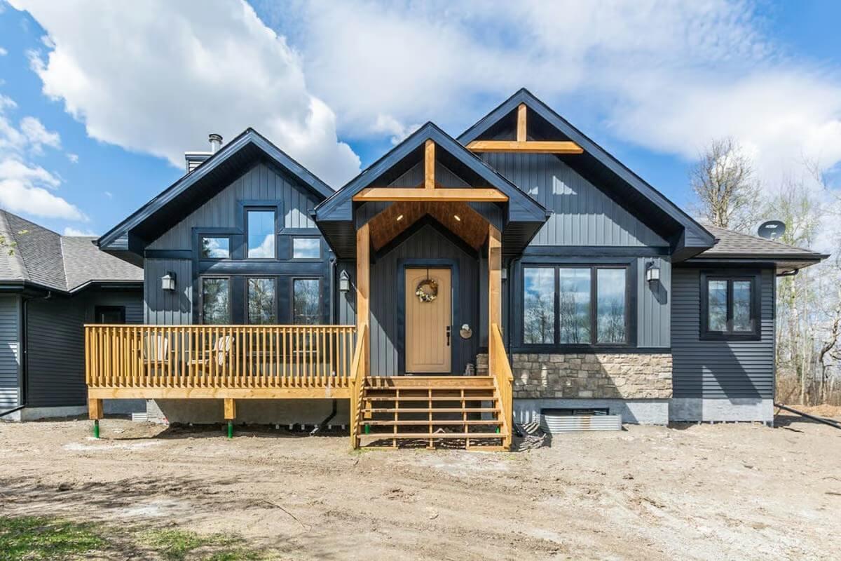 Explore the Striking Gable Roof and Wood Accents of This Modern Home