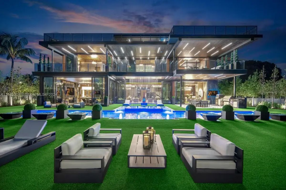 Expansive outdoor living space features a multi-tiered pool with integrated water features and fire bowls.