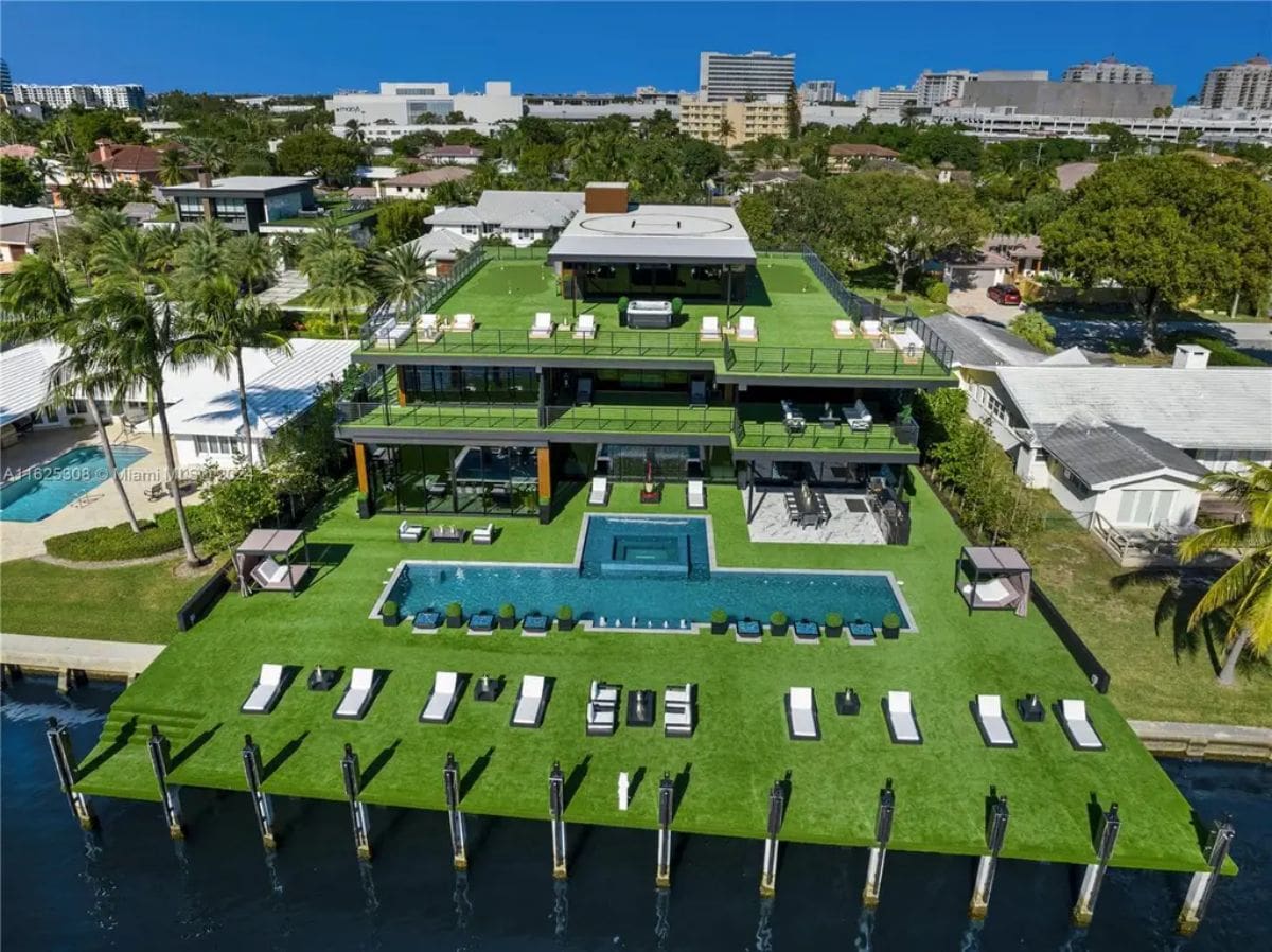 Three-story modern estate features expansive terraces, an infinity pool, and a private dock.
