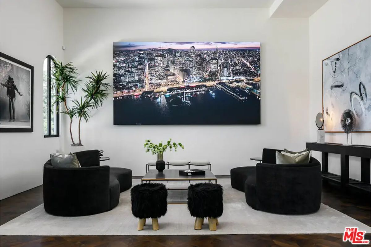 Chic lounge area offers modern black seating, bold cityscape artwork, and stylish decor that creates a cozy ambiance. 