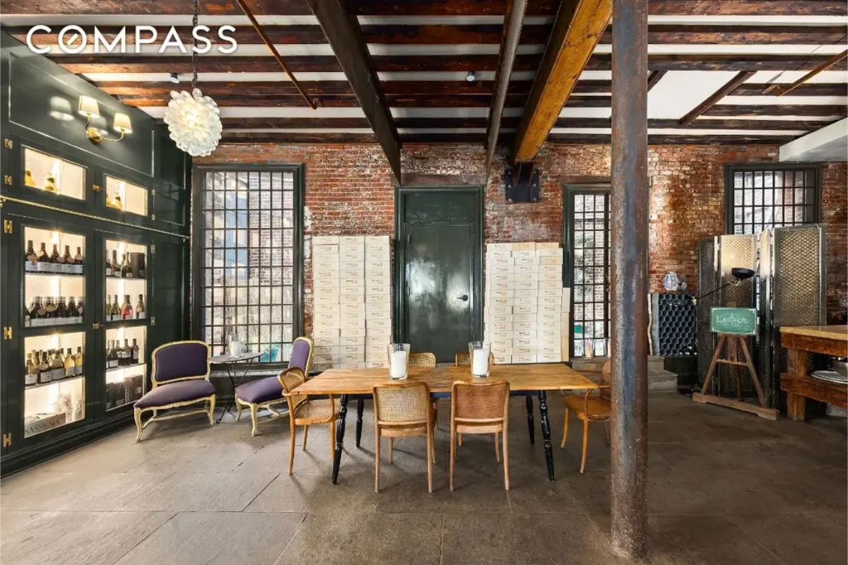 Brick walls and exposed wooden beams create a rustic industrial ambiance.