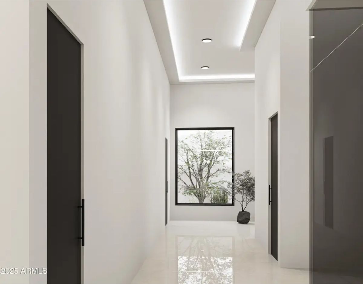 White walls and high-gloss flooring reflect natural light streaming in from a large window.