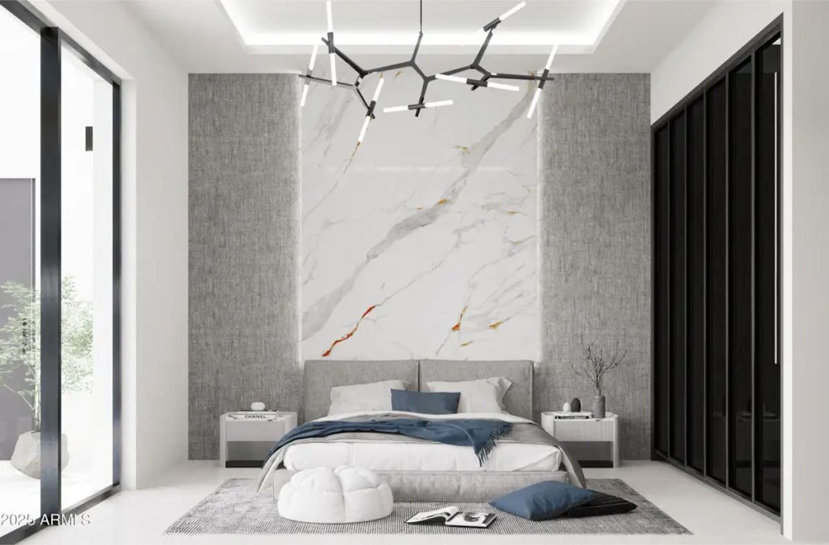 A large slab of white marble with gold veining serves as the central headboard design.