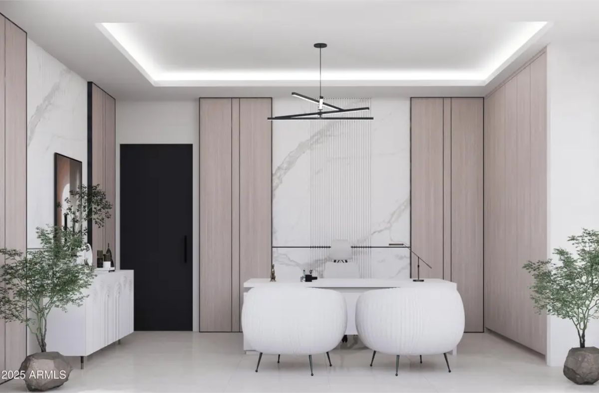 White desk sits against a marble-accented wall with light wood panels.