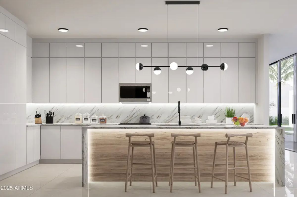 Full-height white cabinetry provides ample storage in this contemporary kitchen.