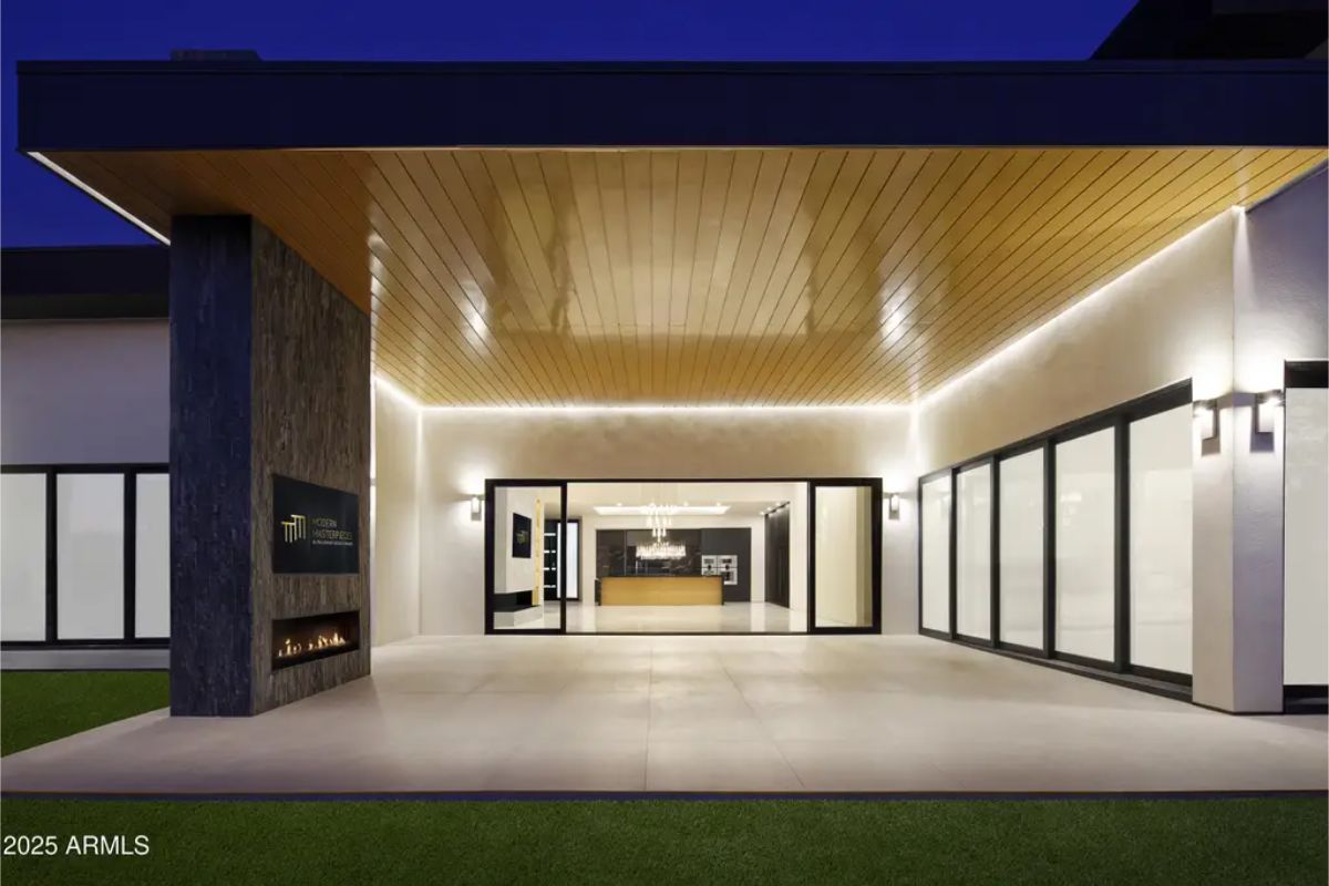 Wood-paneled ceiling with recessed lighting extends over a spacious patio.