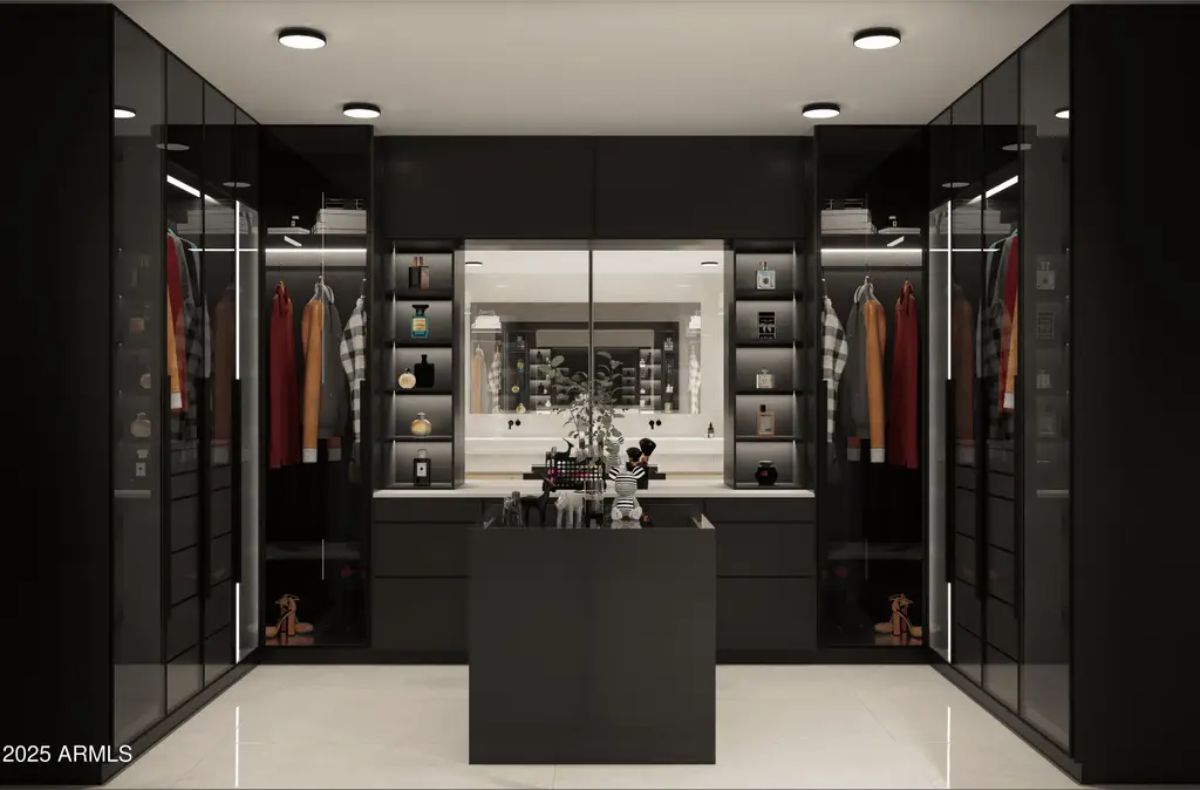 Glass-paneled wardrobes with built-in LED lighting create a sleek, organized display.