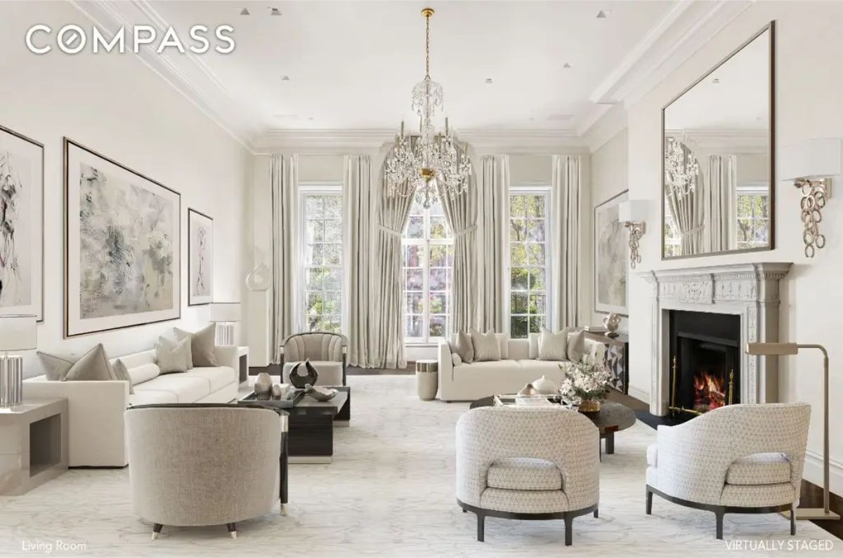 Grand living room with high ceilings, large windows, and neutral-toned furnishings.