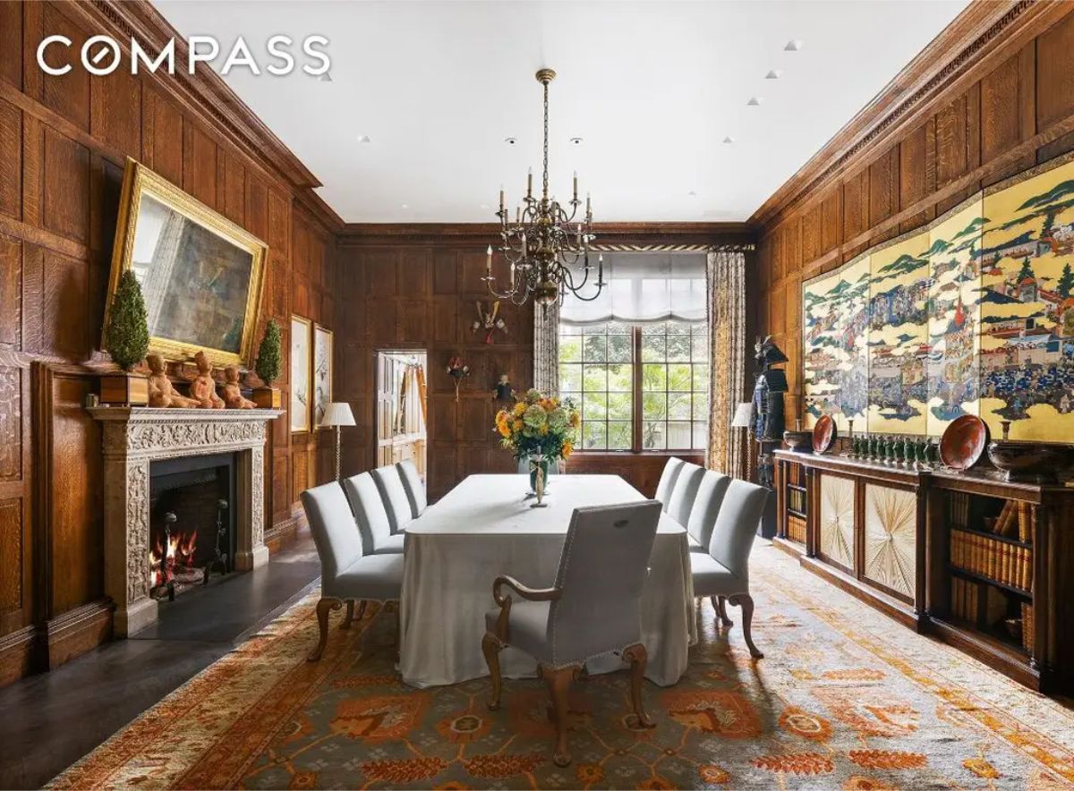 Formal dining room with dark wood paneling and intricate architectural details.