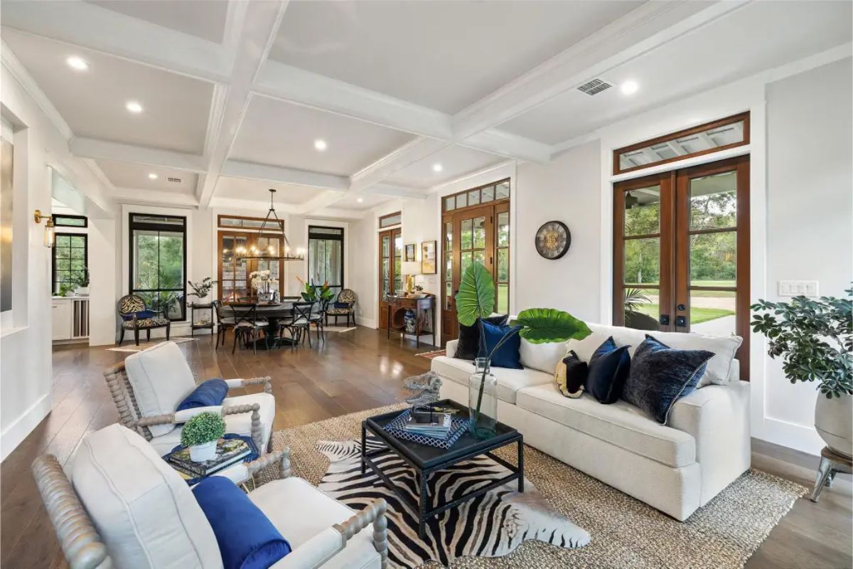 Coffered ceilings, recessed lighting, and large windows.