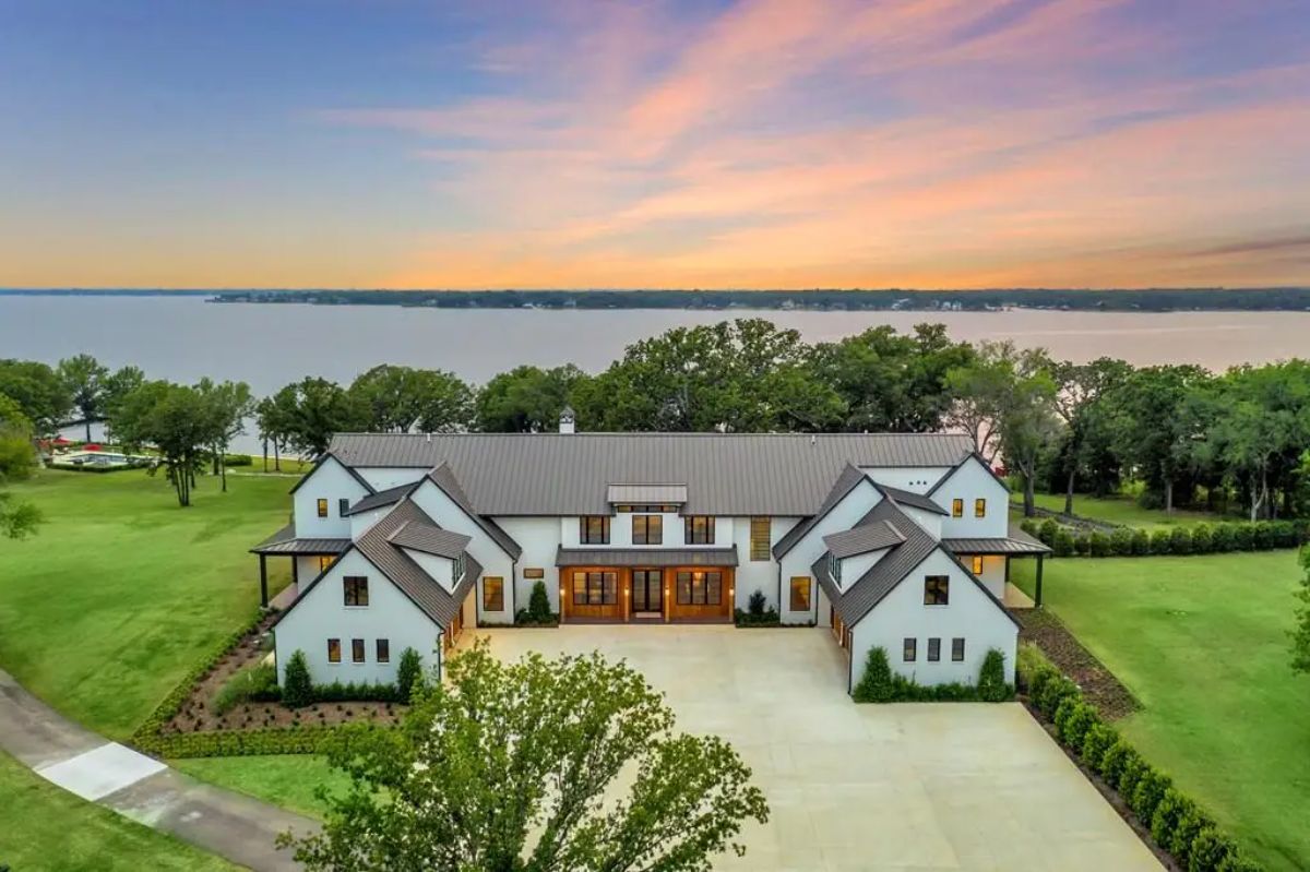 This $18,995,000 estate on Cedar Creek Lake features 15 bedrooms, 16 bathrooms, and 11,000 sq. ft. of living space, including a main house with nine ensuite bedrooms and three guest residences.