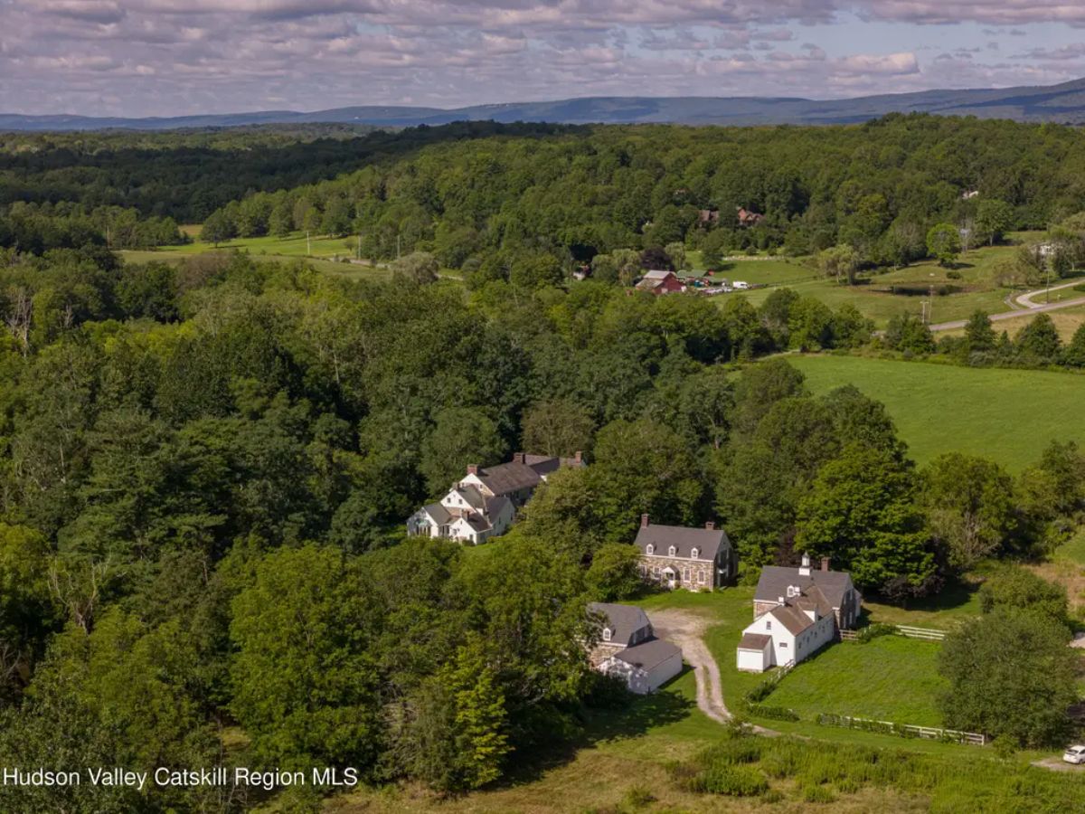 Sprawling estate is nestled within lush green landscapes and rolling hills.