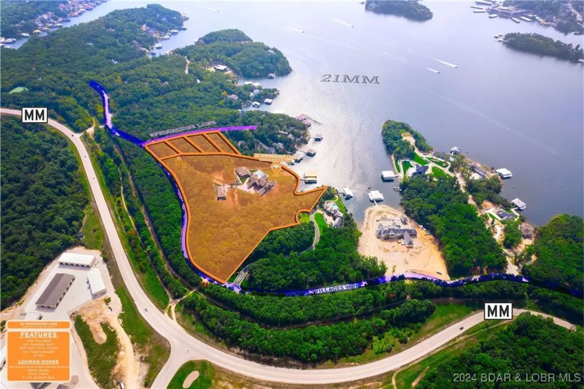 Large estate outlined by wooded acreage with lake access.