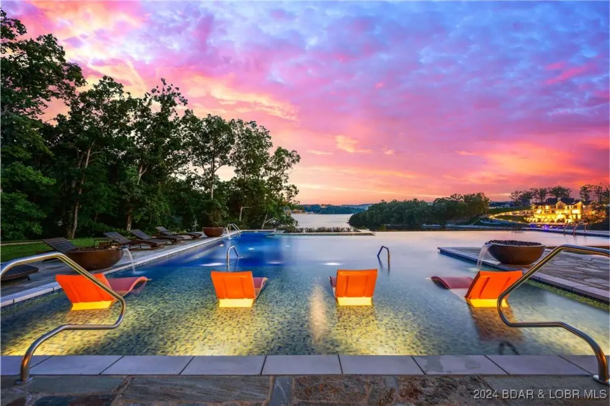 Outdoor pool with an infinity edge blending into the lake view.